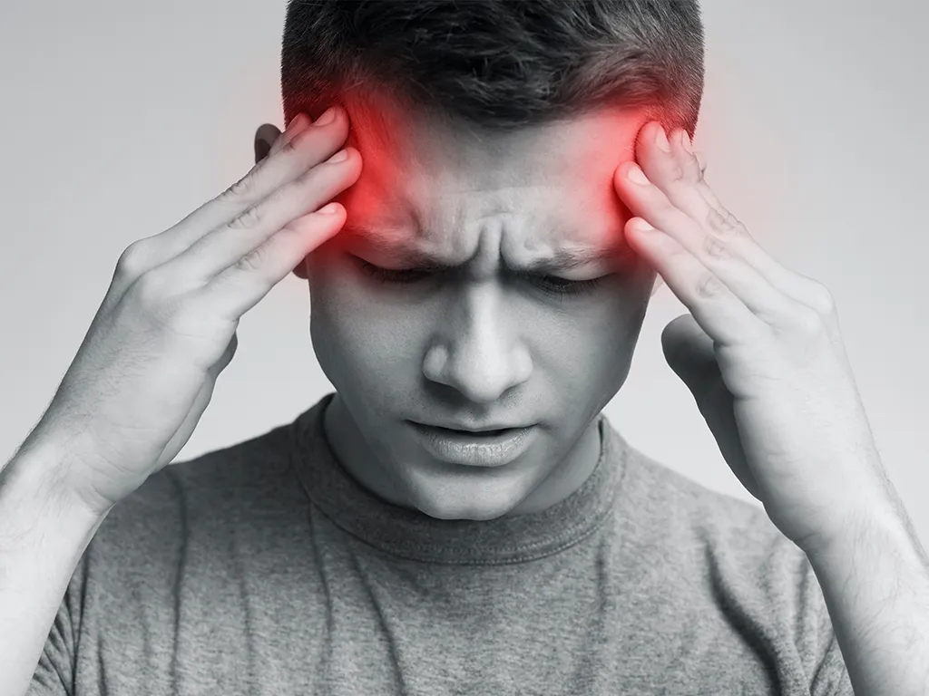 Man holding temples with a headache